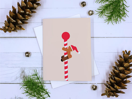 Gingerbread stripper on a peppermint striped pole. Christmas card